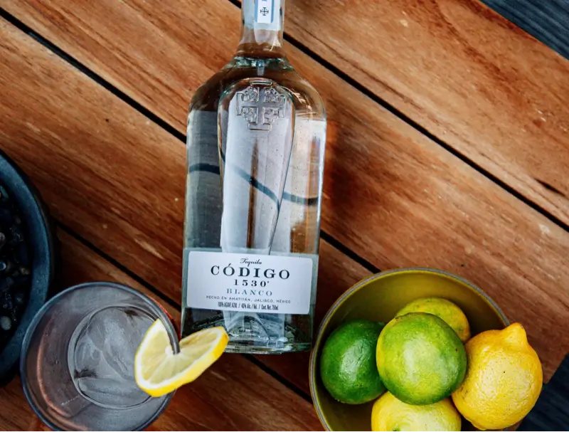 Codigo Blanco with tequila glass and lemons